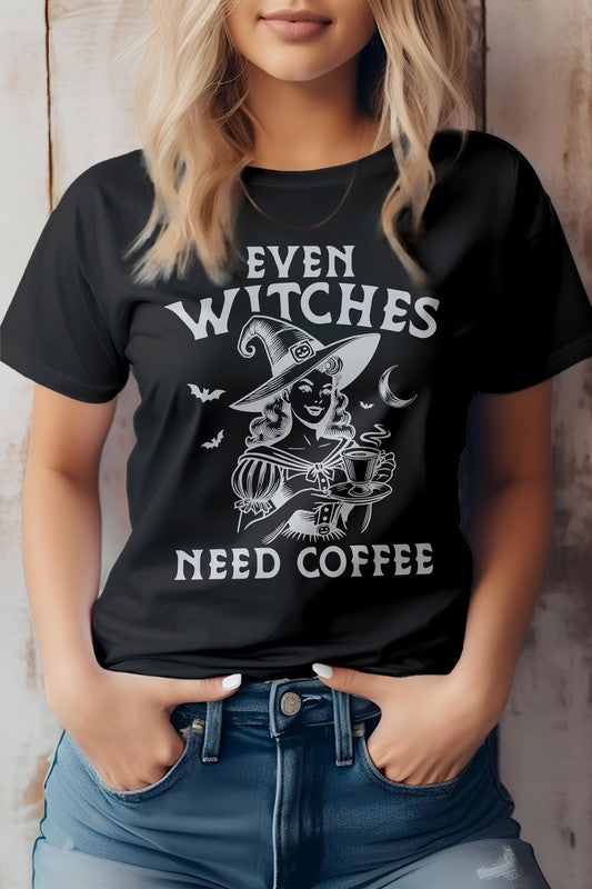 A woman wears the "Even Witches Need Coffee" Halloween Graphic Tee, featuring a witch design and playful purple text. This gray t-shirt, crafted from eco-friendly materials, combines style with a hint of witch magic.