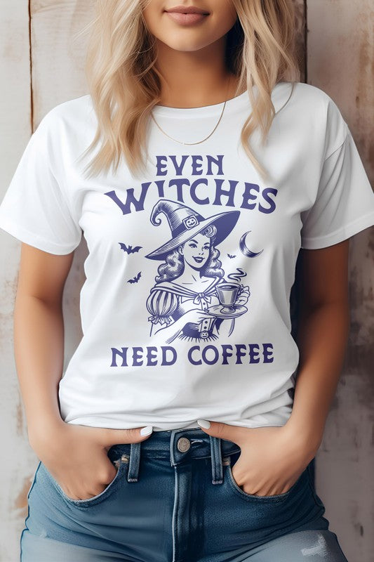 A woman wears the "Even Witches Need Coffee" Halloween Graphic Tee, featuring a witch design and playful purple text. This gray t-shirt, crafted from eco-friendly materials, combines style with a hint of witch magic.