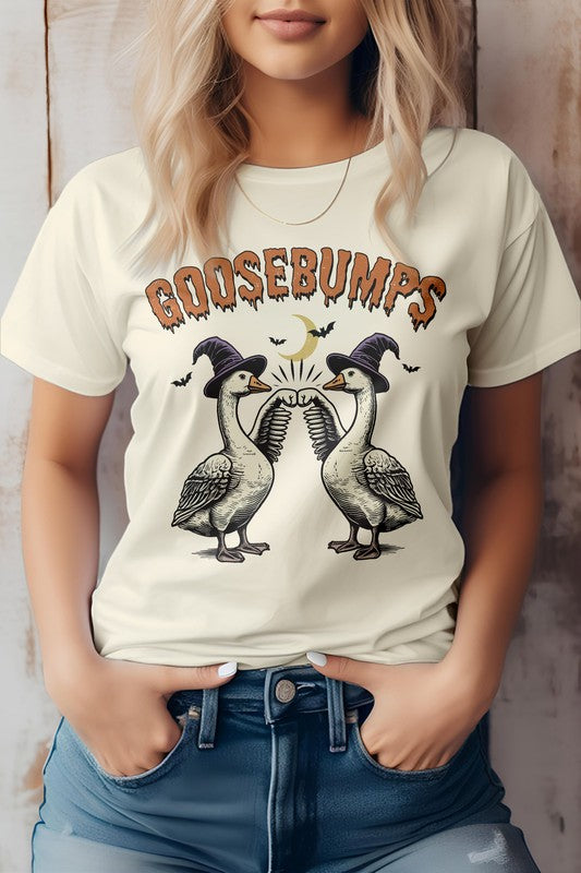 A woman wearing the Vintage Halloween Farm Goose, Graphic Tee, which is eco-friendly and showcases two geese in top hats under the text "Goosebumps." Its unisex fit ensures it's ideal for anyone who appreciates a touch of Vintage Halloween charm.