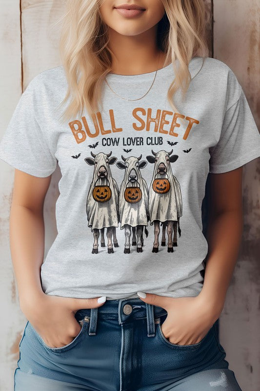 A person wearing the Vintage Bull Sheet Halloween Graphic Tee showcases cows in ghost costumes with Jack-o'-lanterns, sporting the phrase "BULL SHEET COW LOVER CLUB," which exudes a classic Bull Sheet aesthetic ideal for any Cow Lover Club fan.