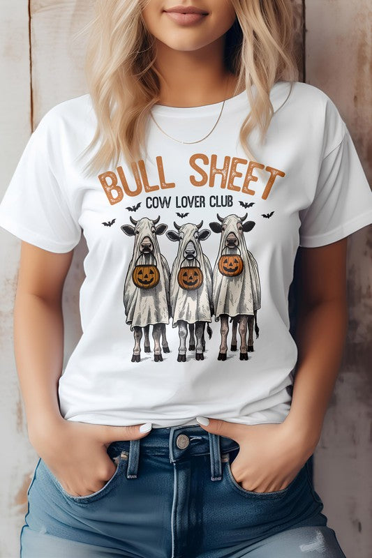 A person wearing the Vintage Bull Sheet Halloween Graphic Tee showcases cows in ghost costumes with Jack-o'-lanterns, sporting the phrase "BULL SHEET COW LOVER CLUB," which exudes a classic Bull Sheet aesthetic ideal for any Cow Lover Club fan.