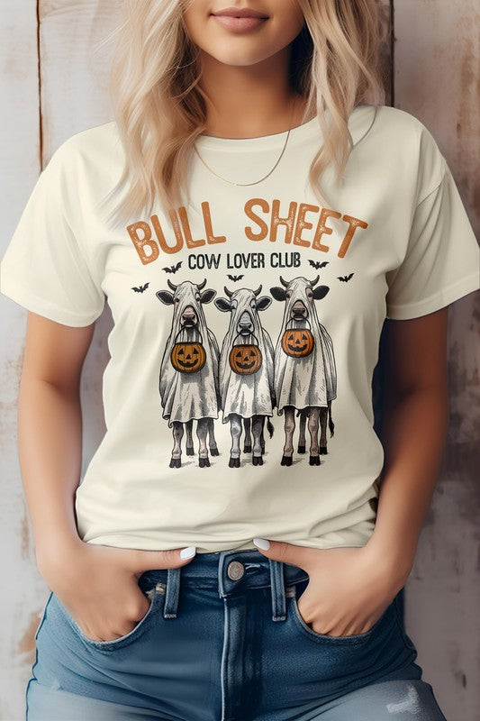 A person wearing the Vintage Bull Sheet Halloween Graphic Tee showcases cows in ghost costumes with Jack-o'-lanterns, sporting the phrase "BULL SHEET COW LOVER CLUB," which exudes a classic Bull Sheet aesthetic ideal for any Cow Lover Club fan.