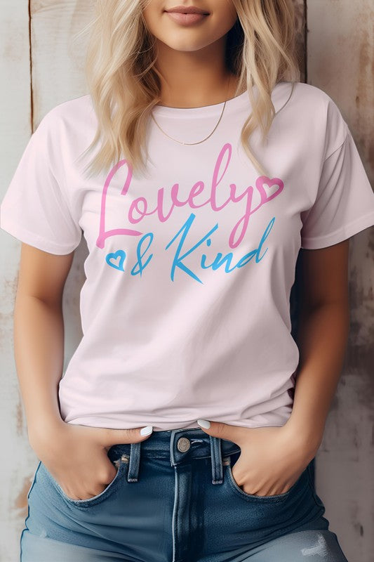 A person stands against a wooden background, wearing an eco-friendly pink T-shirt from Bella Canvas Tees. The "Love & Kind" message shines in pink and blue text, reflecting both style and substance.