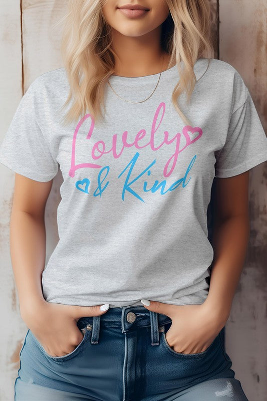 A person stands against a wooden background, wearing an eco-friendly pink T-shirt from Bella Canvas Tees. The "Love & Kind" message shines in pink and blue text, reflecting both style and substance.