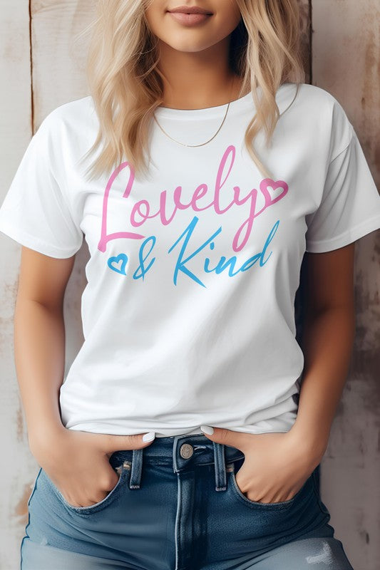 A person stands against a wooden background, wearing an eco-friendly pink T-shirt from Bella Canvas Tees. The "Love & Kind" message shines in pink and blue text, reflecting both style and substance.