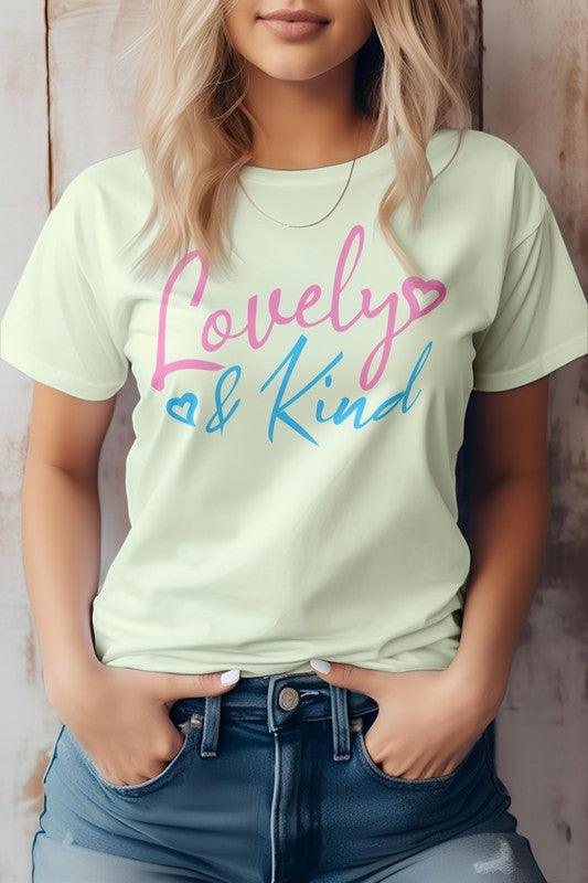 A person stands against a wooden background, wearing an eco-friendly pink T-shirt from Bella Canvas Tees. The "Love & Kind" message shines in pink and blue text, reflecting both style and substance.