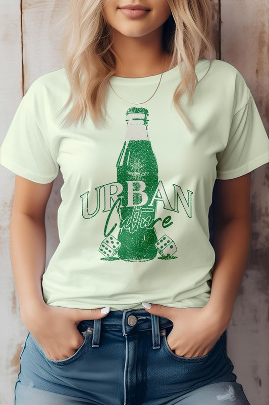 A person wearing the Urban Culture Street Graphic Tee in light green, featuring a vintage Coca-Cola bottle design, stands with hands in jeans pockets.