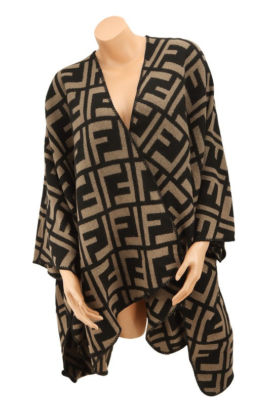 The Greek Pattern Poncho is a black and white poncho featuring an all-over geometric Greek pattern and an asymmetrical hem.