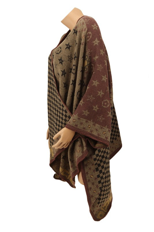 The Geometric Pattern Poncho features a brown color with an eclectic mix of designs, including checks, stars, and abstract shapes, all beautifully draped on a plain background.