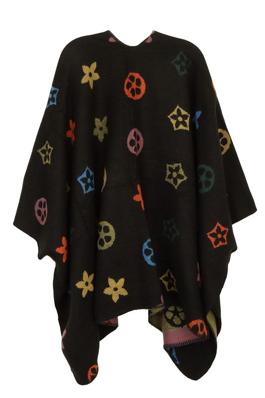 A black poncho featuring a colorful floral and geometric pattern. Styled open in the front with a draped design, this piece offers the elegance of the Multi Color and Geometric Pattern Poncho.