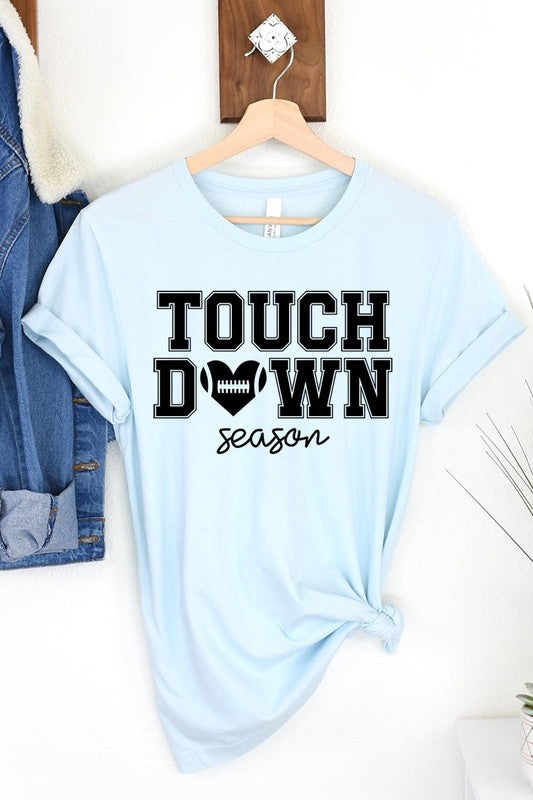 A Touchdown Season Graphic Tee in dark gray with a high-quality direct-to-film printed design, paired with blue jeans and beige ankle boots, laid out flat.