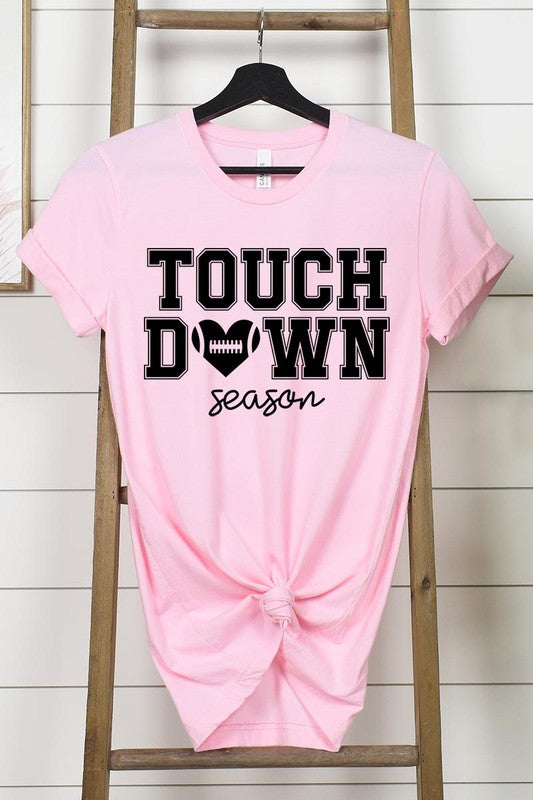 A Touchdown Season Graphic Tee in dark gray with a high-quality direct-to-film printed design, paired with blue jeans and beige ankle boots, laid out flat.