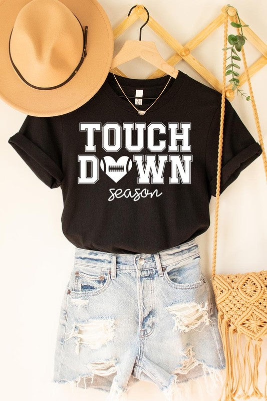 A Touchdown Season Graphic Tee in dark gray with a high-quality direct-to-film printed design, paired with blue jeans and beige ankle boots, laid out flat.