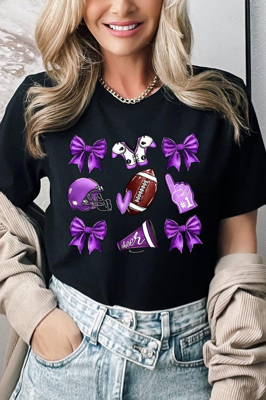 Someone wearing a Purple Coquette Football Graphic Tee, a unisex crew neck pink t-shirt decorated with sports-themed illustrations like a football, helmet, megaphone, foam finger, and cheerleading accessories in purple and white.