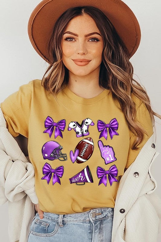 Someone wearing a Purple Coquette Football Graphic Tee, a unisex crew neck pink t-shirt decorated with sports-themed illustrations like a football, helmet, megaphone, foam finger, and cheerleading accessories in purple and white.