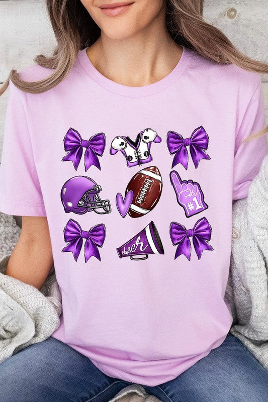 Someone wearing a Purple Coquette Football Graphic Tee, a unisex crew neck pink t-shirt decorated with sports-themed illustrations like a football, helmet, megaphone, foam finger, and cheerleading accessories in purple and white.