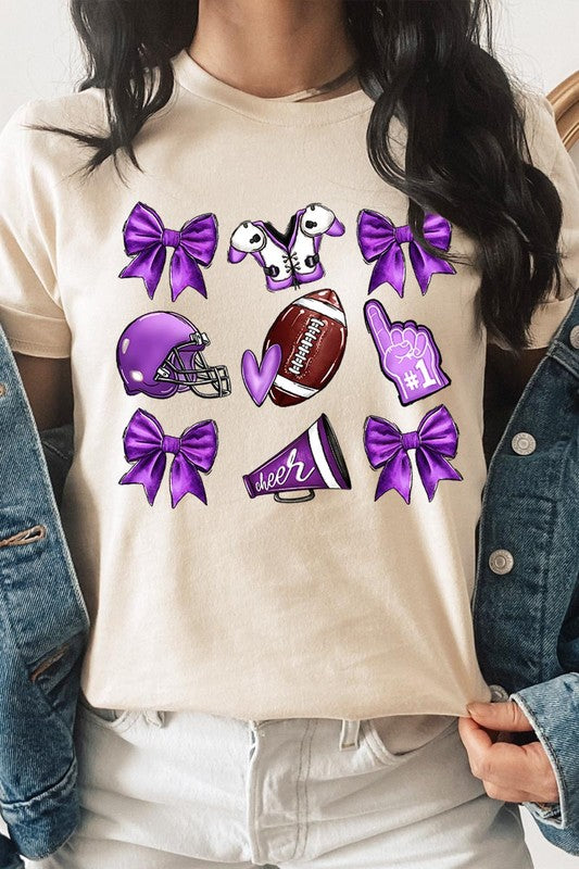 Someone wearing a Purple Coquette Football Graphic Tee, a unisex crew neck pink t-shirt decorated with sports-themed illustrations like a football, helmet, megaphone, foam finger, and cheerleading accessories in purple and white.