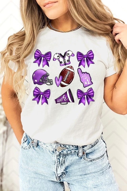 Someone wearing a Purple Coquette Football Graphic Tee, a unisex crew neck pink t-shirt decorated with sports-themed illustrations like a football, helmet, megaphone, foam finger, and cheerleading accessories in purple and white.