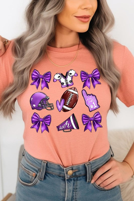 Someone wearing a Purple Coquette Football Graphic Tee, a unisex crew neck pink t-shirt decorated with sports-themed illustrations like a football, helmet, megaphone, foam finger, and cheerleading accessories in purple and white.