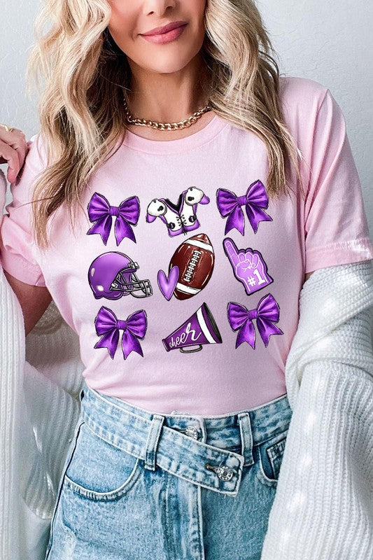 Someone wearing a Purple Coquette Football Graphic Tee, a unisex crew neck pink t-shirt decorated with sports-themed illustrations like a football, helmet, megaphone, foam finger, and cheerleading accessories in purple and white.