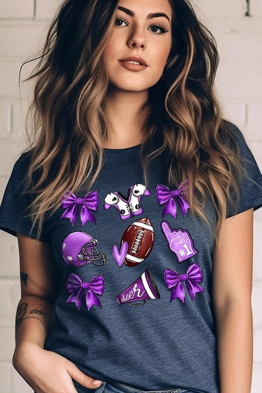 Someone wearing a Purple Coquette Football Graphic Tee, a unisex crew neck pink t-shirt decorated with sports-themed illustrations like a football, helmet, megaphone, foam finger, and cheerleading accessories in purple and white.