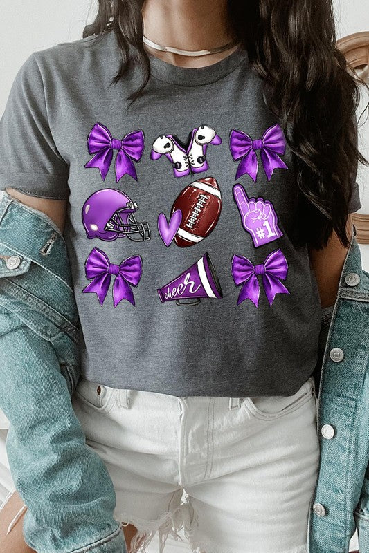 Someone wearing a Purple Coquette Football Graphic Tee, a unisex crew neck pink t-shirt decorated with sports-themed illustrations like a football, helmet, megaphone, foam finger, and cheerleading accessories in purple and white.