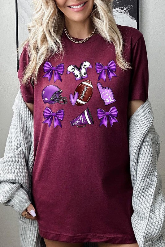 Someone wearing a Purple Coquette Football Graphic Tee, a unisex crew neck pink t-shirt decorated with sports-themed illustrations like a football, helmet, megaphone, foam finger, and cheerleading accessories in purple and white.