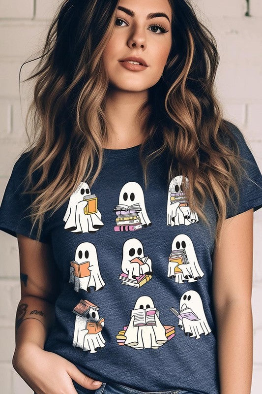 A person wears a brown shirt featuring illustrations of cute ghosts reading, holding, and interacting with books. This Funny Ghost Book Nerd Graphic Tee is paired with a partially worn denim jacket, showcasing its high-quality printed design.