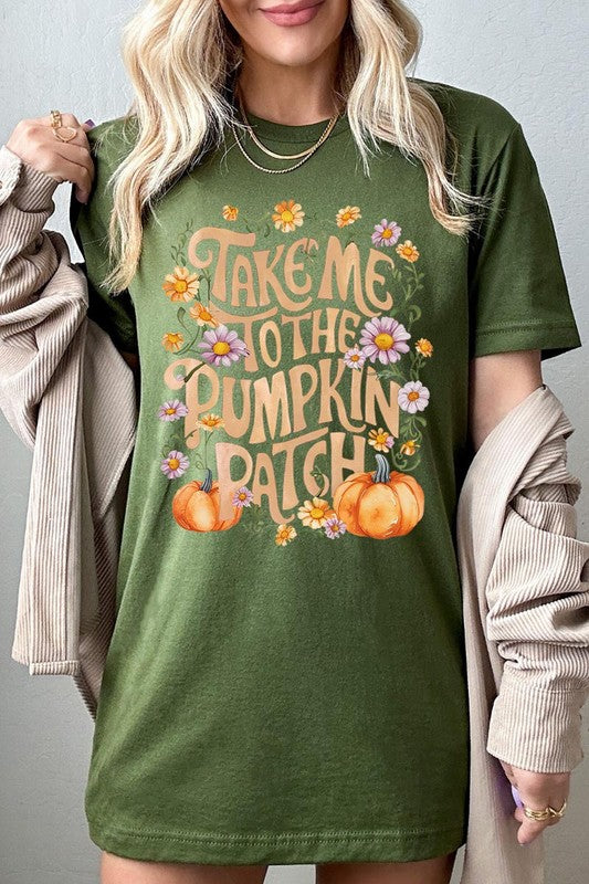 Person wearing a Take Me To The Pumpkin Patch Graphic Tee, which is a navy blue unisex crew neck t-shirt featuring the words "Take me to the pumpkin patch" surrounded by flowers and pumpkins.