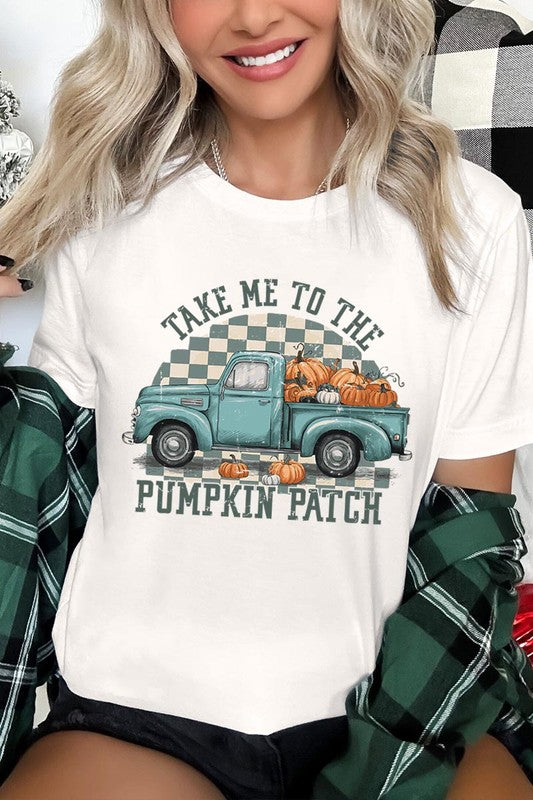 A woman wearing the "Take Me To The Pumpkin Patch Graphic Tee" featuring an illustration of a teal truck carrying pumpkins and the text "Take Me to the Pumpkin Patch." She has a green plaid shirt draped over her shoulders, creating a perfect match for Family Group Uniforms.