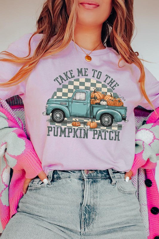 A woman wearing the "Take Me To The Pumpkin Patch Graphic Tee" featuring an illustration of a teal truck carrying pumpkins and the text "Take Me to the Pumpkin Patch." She has a green plaid shirt draped over her shoulders, creating a perfect match for Family Group Uniforms.