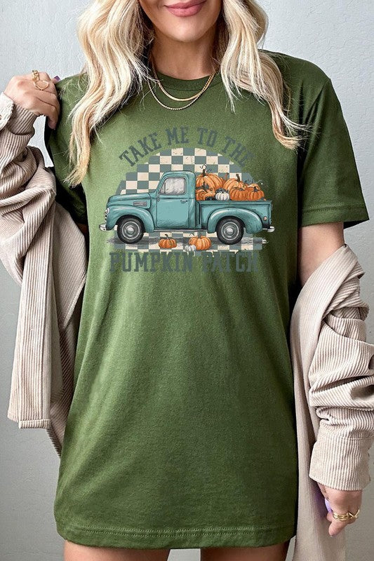 A woman wearing the "Take Me To The Pumpkin Patch Graphic Tee" featuring an illustration of a teal truck carrying pumpkins and the text "Take Me to the Pumpkin Patch." She has a green plaid shirt draped over her shoulders, creating a perfect match for Family Group Uniforms.