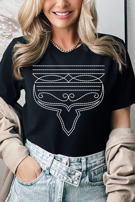 A person wearing the Western Boot Stitch Graphic Tee, featuring a geometric design and holding the bottom of the shirt, has a denim jacket draped over their shoulders.