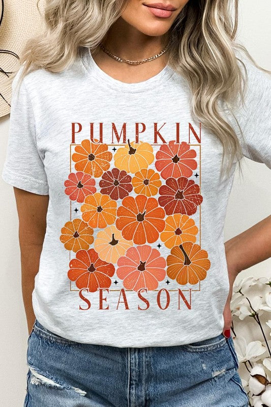 Person wearing a Pumpkin Season Boho Graphic Tee adorned with floral pumpkin designs, paired with a beige cardigan.