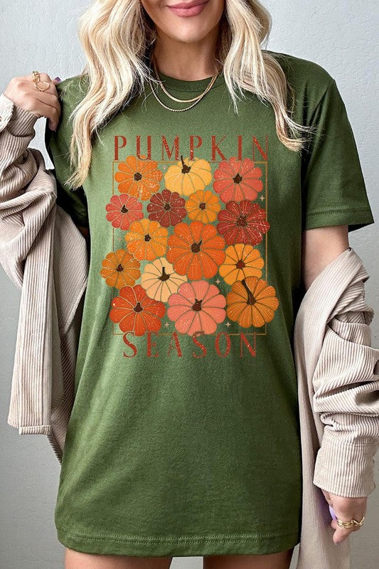 Person wearing a Pumpkin Season Boho Graphic Tee adorned with floral pumpkin designs, paired with a beige cardigan.