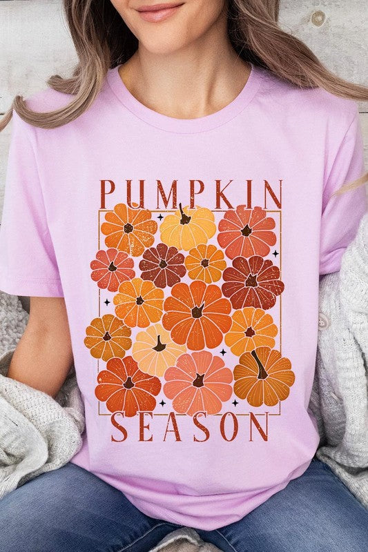 Person wearing a Pumpkin Season Boho Graphic Tee adorned with floral pumpkin designs, paired with a beige cardigan.