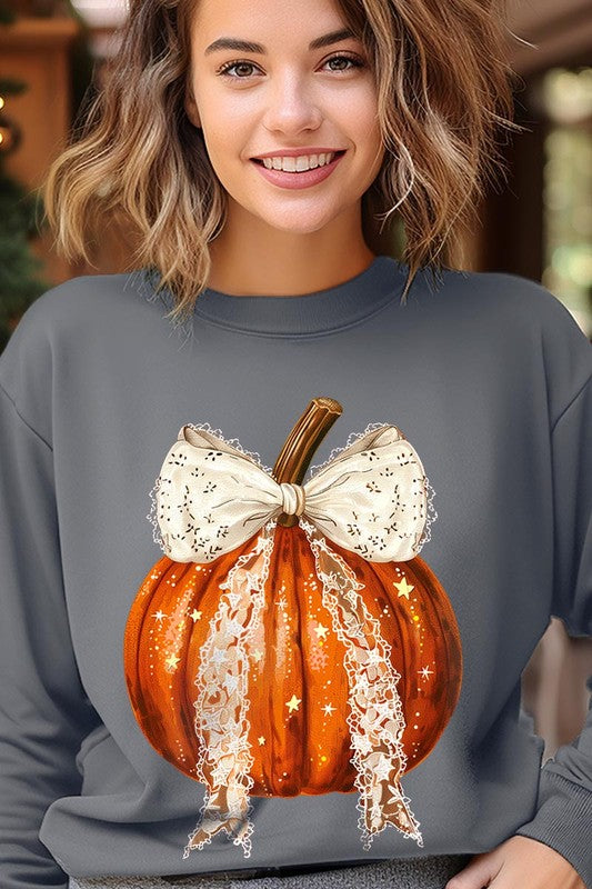 A person wearing the Coquette bow Halloween Pumpkin Fleece Sweatshirt, which features a black unisex crew neck design with a printed Halloween pumpkin graphic adorned with a large, lacy white bow.