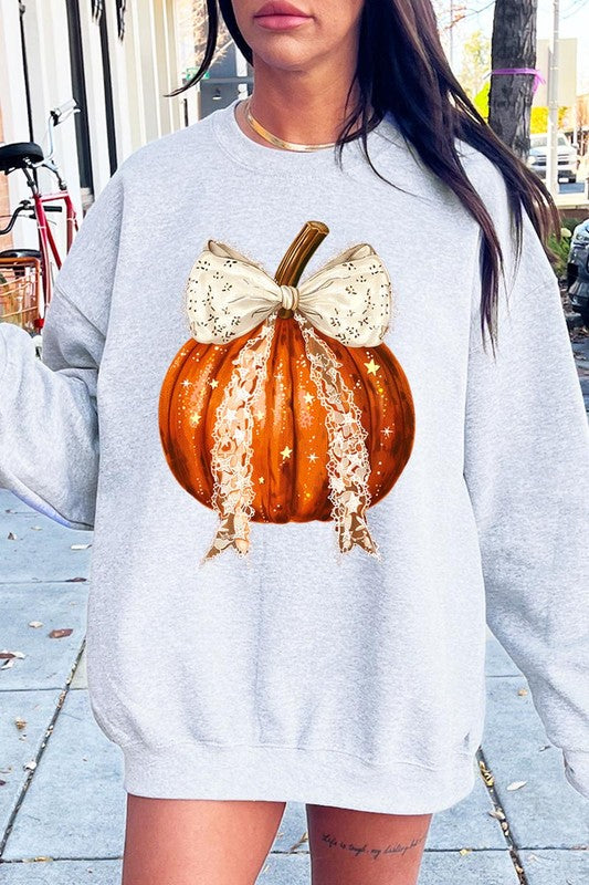 A person wearing the Coquette bow Halloween Pumpkin Fleece Sweatshirt, which features a black unisex crew neck design with a printed Halloween pumpkin graphic adorned with a large, lacy white bow.