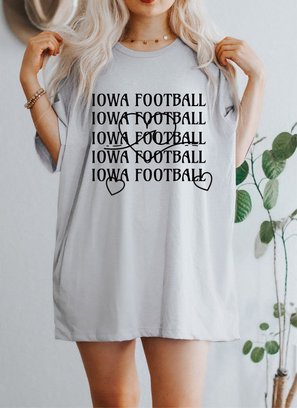 Person standing with hands on hips wearing an Iowa Football Wave Heart Graphic Crew Tee and black shorts.