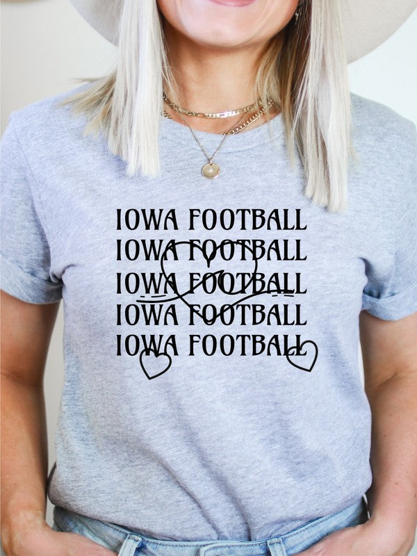 Person standing with hands on hips wearing an Iowa Football Wave Heart Graphic Crew Tee and black shorts.