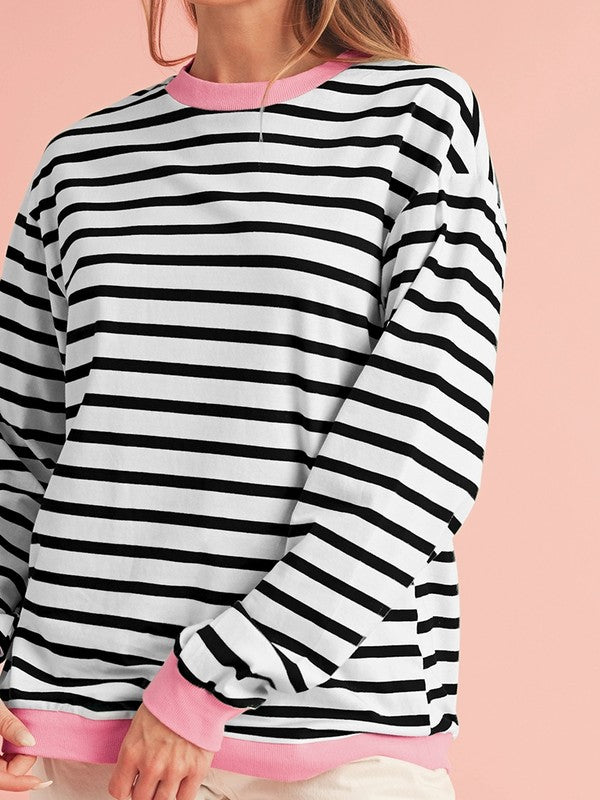 A person wearing the Cotton Stripe Drop Shoulder Sweatshirt, which features green stripes and pink cuffs, is facing away from the camera against a pink background.