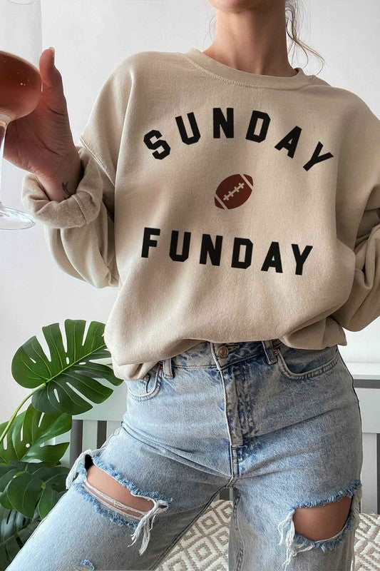 A person wearing a SUNDAY FUN DAY FOOTBALL GRAPHIC SWEATSHIRT, taking a selfie.