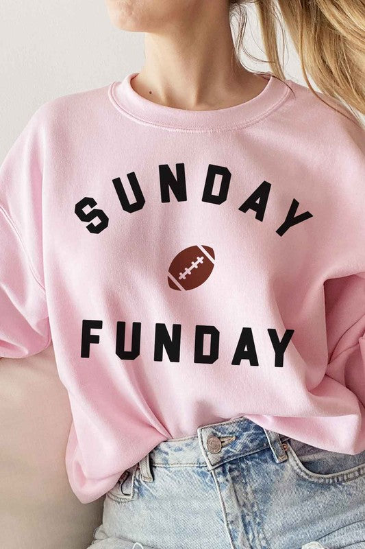 A person wearing a SUNDAY FUN DAY FOOTBALL GRAPHIC SWEATSHIRT, taking a selfie.