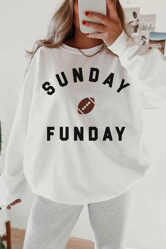 A person wearing a SUNDAY FUN DAY FOOTBALL GRAPHIC SWEATSHIRT, taking a selfie.