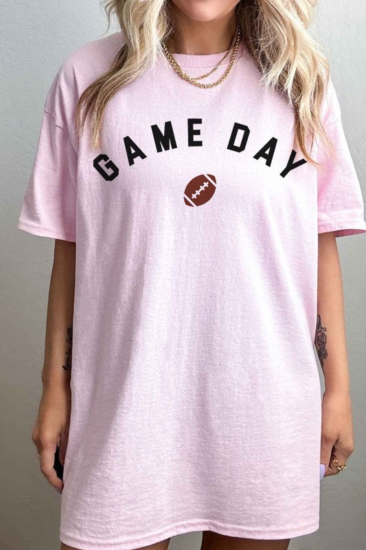 A person wearing the GAME DAY FOOTBALL TAILGATE GRAPHIC TEE, made from premium cotton in beige, with "GAME DAY" and a football image printed on the front, ready for a football tailgate.