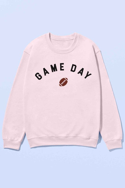 Individual dressed in the GAME DAY FOOTBALL TAILGATE OVERSIZED SWEATSHIRT in light gray, featuring "GAME DAY" and a football graphic on the front, teamed with black shorts.