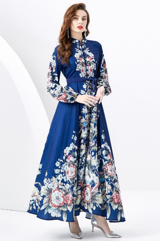 A woman in a WOMEN FASHION LONG MAXI DRESS with a blue long-sleeve and floral multi-print stands against a white background.