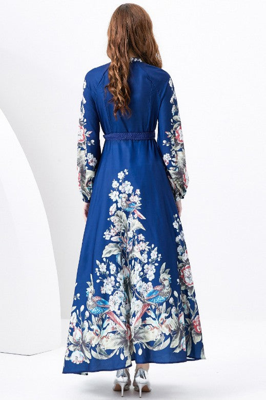 A woman in a WOMEN FASHION LONG MAXI DRESS with a blue long-sleeve and floral multi-print stands against a white background.