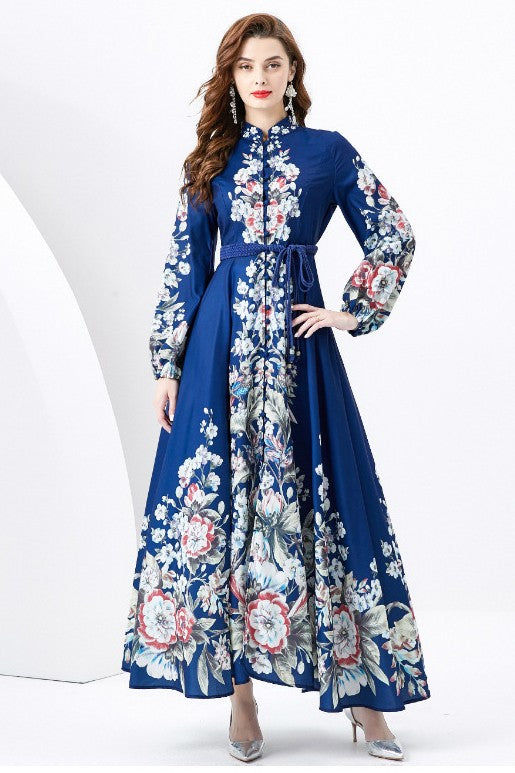 A woman in a WOMEN FASHION LONG MAXI DRESS with a blue long-sleeve and floral multi-print stands against a white background.