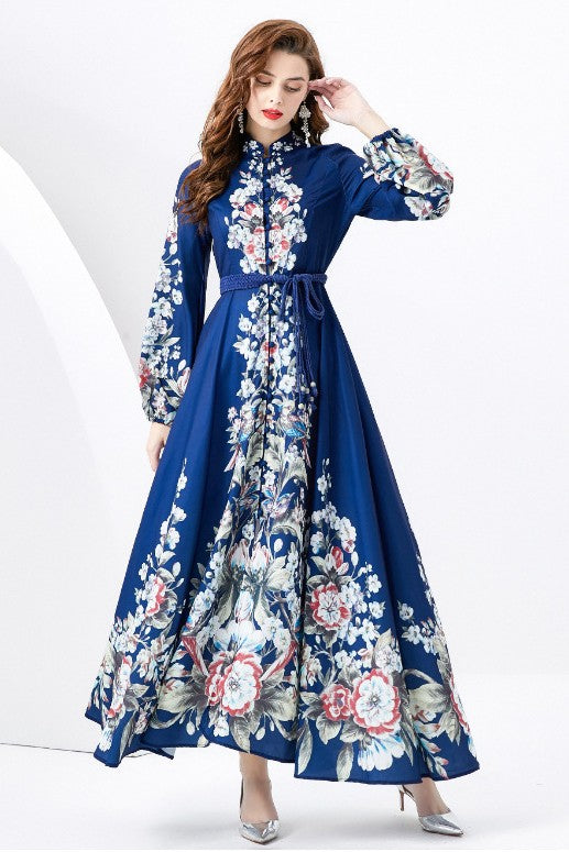 A woman in a WOMEN FASHION LONG MAXI DRESS with a blue long-sleeve and floral multi-print stands against a white background.